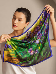 Mulberry silk scarf with vibrant floral oil painting design, 53x53cm, held by a woman.