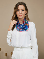 Woman wearing a blue mulberry silk floral pattern scarf, 53x53cm, with a white shirt.