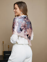 Woman wearing a mulberry silk floral pattern square scarf in pink and grey.