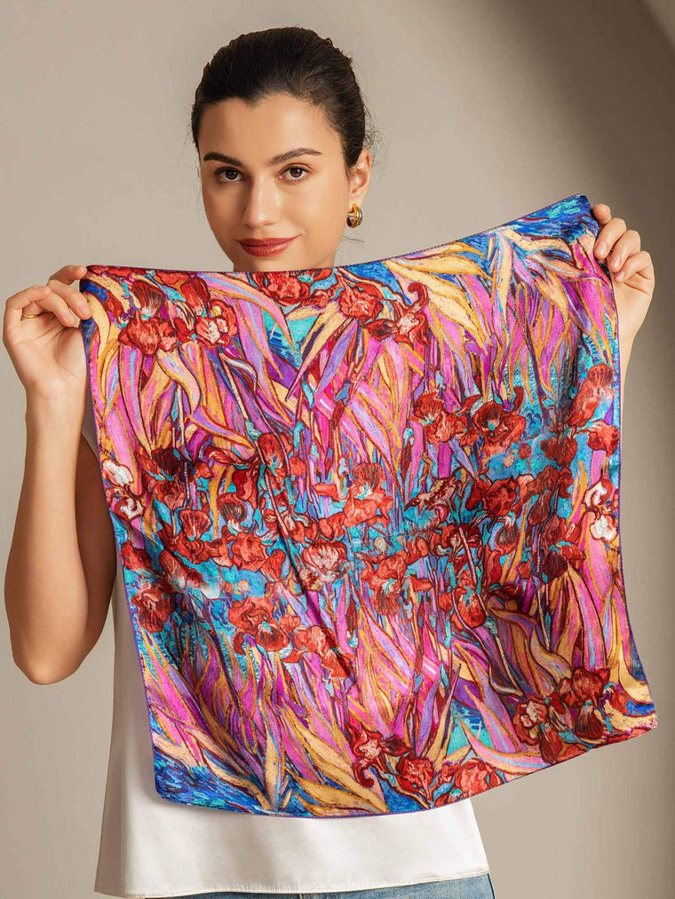 Woman holding a vibrant mulberry silk floral pattern square scarf, 53x53cm.