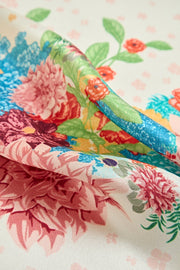 Mulberry silk floral square scarf with vibrant flowers and green trim.