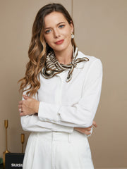 Woman wearing a 100% Mulberry silk geometric pattern square scarf, 53x53cm, in brown and white.
