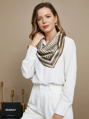 Woman wearing a 100% mulberry silk geometric pattern square scarf in brown and white.