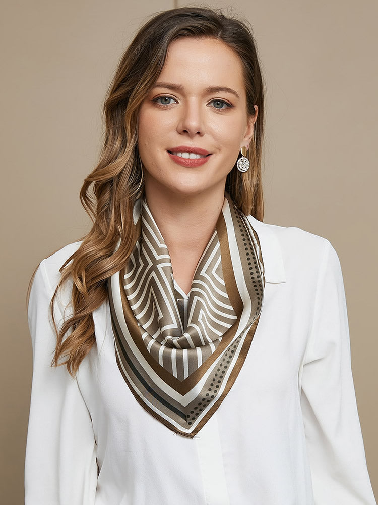 Woman wearing a 100% Mulberry silk geometric pattern square scarf in brown and white, 53x53cm.