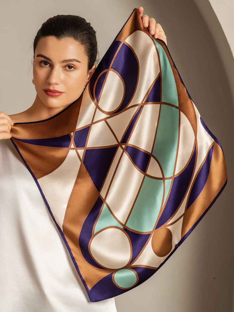 Mulberry silk geometric pattern square scarf, 53x53cm, held by a woman.