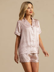 Women's mulberry silk short sleeve pajamas with pink and blue geometric print, notch collar, and white piping.