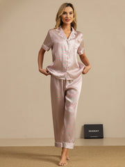 Women's mulberry silk pajamas: pink heart geo print, short sleeve notch collar top, and pants.