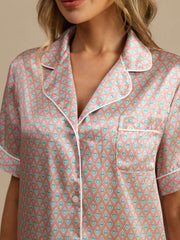 Women's mulberry silk short sleeve pajamas with pink and teal geometric print, notch collar, and white piping.