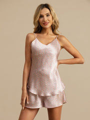 Women's mulberry silk camisole and shorts set with a pink geometric print, V-neck, and spaghetti straps.
