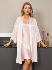 Blonde woman wearing a pink mulberry silk kimono robe and V-neck nightgown set.