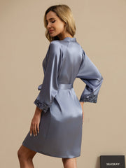 Women's mulberry silk robe in dusty blue with lace cuffs and 3/4 sleeves.