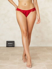 Red mulberry silk lace thong panty on a model, showcasing its delicate lace trim.