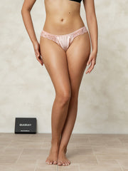 Pink mulberry silk lace thong panty on a woman, featuring delicate lace trim.