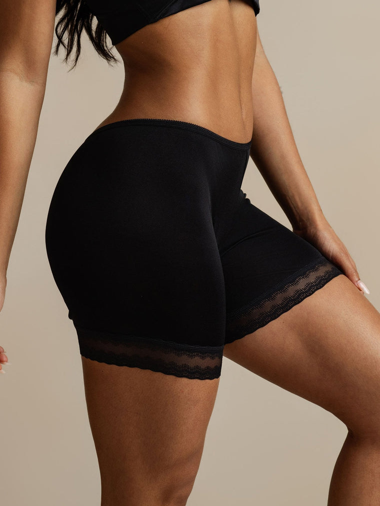 Black mulberry silk lace trim anti-chafing shorts on a model.