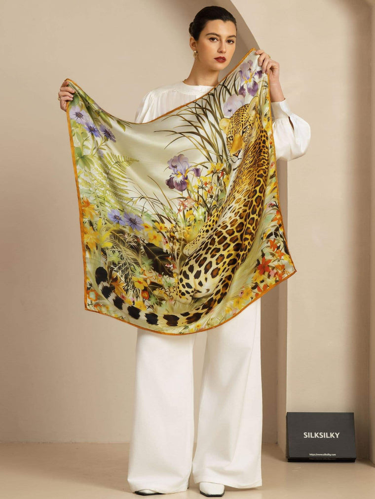 Mulberry silk leopard & floral scarf (90x90cm) held by a woman in white.