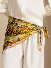Mulberry silk leopard & floral scarf, 90x90cm, tied around a waist over white clothing.