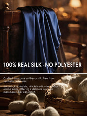 Navy blue mulberry silk long scarf draped over a wooden chair, highlighting its smooth, luxurious texture.