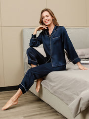 Women's navy blue 100% mulberry silk long sleeve button-up pajama set with white piping.