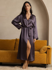 Women's mulberry silk long sleeve midi robe in a deep plum color, tied at the waist, with a high slit.