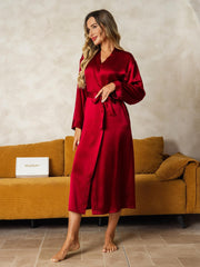 Women's long sleeve mulberry silk midi robe in elegant red, tied at the waist.