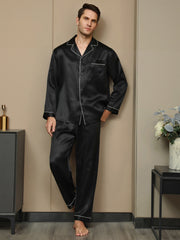 Men's black mulberry silk pajama set with long sleeves, notch collar, and white piping detail.