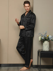 Men's black mulberry silk pajama set with long sleeves, notch collar, and white piping detail.