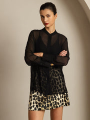Women's black sheer mulberry silk blouse with leopard print split hem.