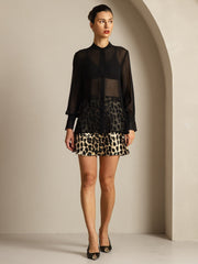 Black sheer mulberry silk long sleeve blouse with a leopard print skirt.