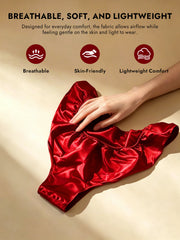 Red mulberry silk low-rise panty with ruffle trim, held by a hand.