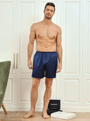 Man modeling navy blue mulberry silk lounge shorts with an elastic waistband.