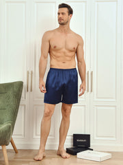 Man wearing navy blue mulberry silk lounge shorts.