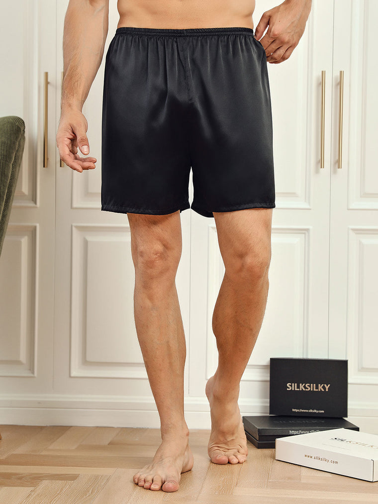 Men's black mulberry silk lounge shorts with elastic waist, shown on a model.