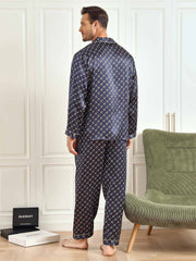 Men's navy mulberry silk pajamas with gold chain print, long sleeves, and pants.