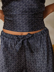 Navy mulberry silk camisole set with ginkgo print, spaghetti straps, V-neck, and bow-tie waist.
