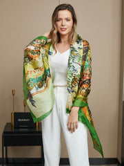 Woman wearing a vibrant mulberry silk oil painting rectangle scarf with green borders.