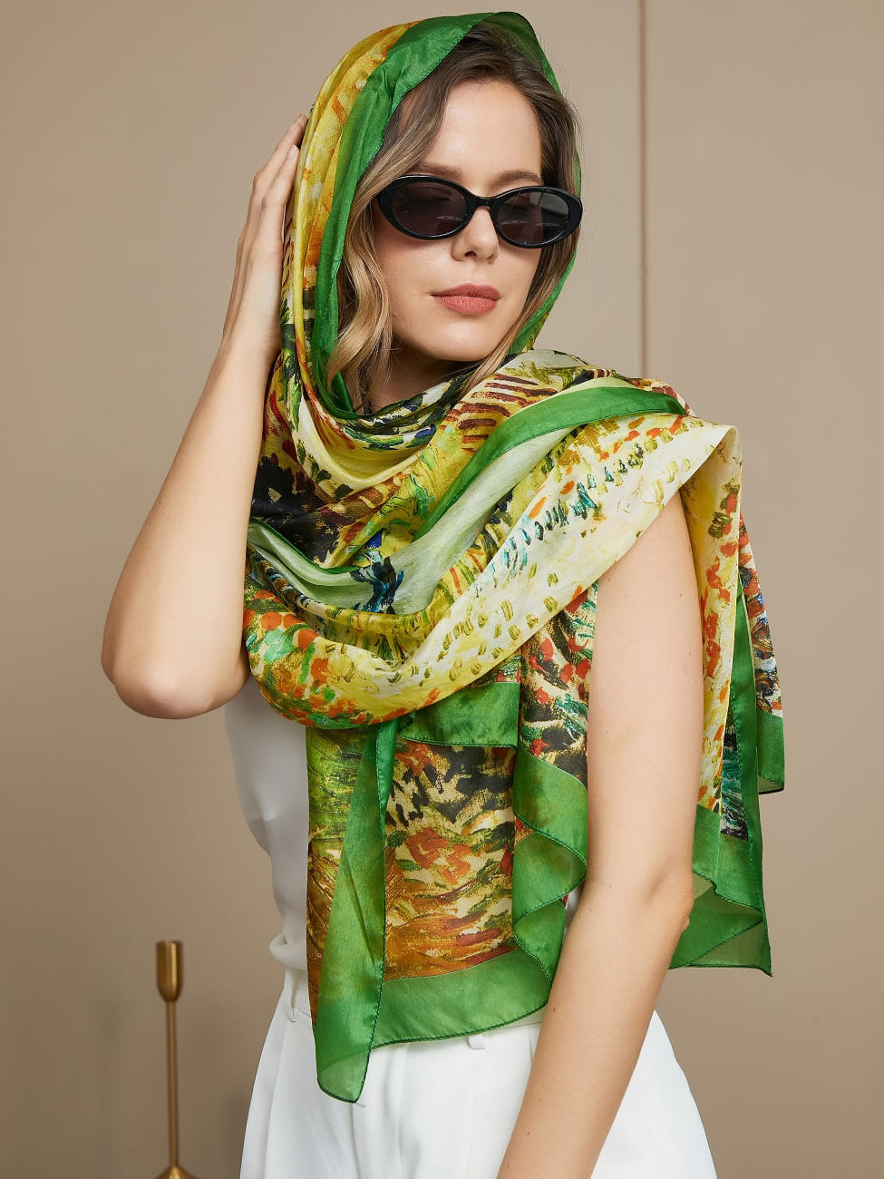 Woman wearing a vibrant green and yellow mulberry silk scarf with an oil painting design.