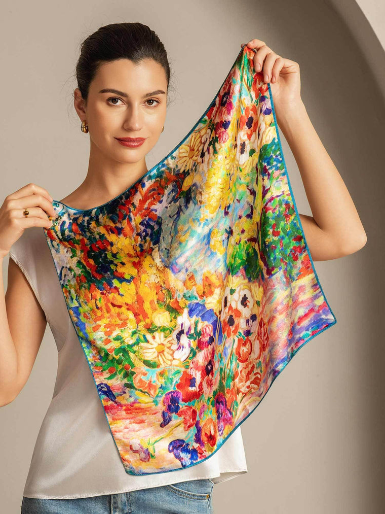 Woman holding a vibrant mulberry silk scarf with an oil painting floral design, 53x53cm.