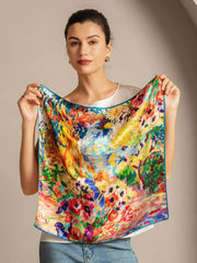 Woman holding a vibrant mulberry silk square scarf with an abstract oil painting floral design.