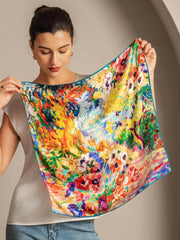 Woman holding a colorful 100% Mulberry silk oil painting square scarf, 53x53cm, with vibrant floral art.