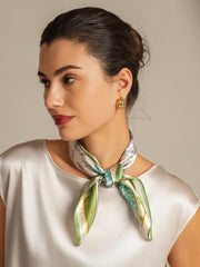 Woman wearing a 100% mulberry silk pattern stitching square scarf with green and blue accents.