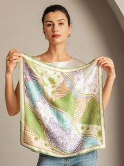Woman holding a 53x53cm mulberry silk scarf with a colorful patterned stitching design.