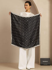 Black mulberry silk paw print square scarf, 90x90cm, held by a woman in white.
