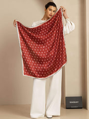 Mulberry silk scarf, 90x90cm, in red with white paw print pattern, held by a woman.