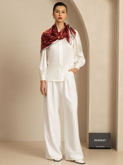 Mulberry silk paw print square scarf, 90x90cm, in rich red with white details, styled on a model.