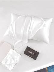 White mulberry silk pillowcase with envelope closure, folded and in a gift box.