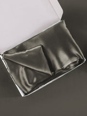 Dark gray mulberry silk pillowcase with envelope closure, folded in an open white box.