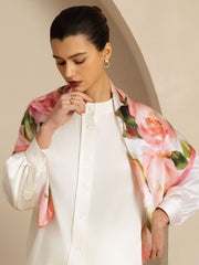 Woman wearing a 90x90cm 100% Mulberry silk pink floral print square scarf over a white shirt.