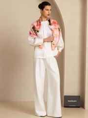 Model wearing a 90x90cm mulberry silk pink floral print square scarf over a white outfit.