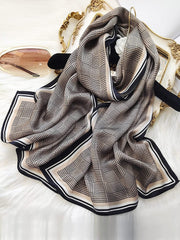 Mulberry silk printed long rectangle shawl scarf with a black and beige plaid pattern and striped border.