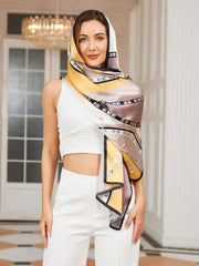 Woman wearing a mulberry silk printed rectangular long shawl scarf with yellow, brown, and black patterns.